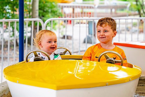 NIC ADAM / FREE PRESS
Brothers Bodhi, 1, and Ozzy Shaw, 6, take a boat ride at Tinker Town Monday afternoon.
240826 - Monday, August 26, 2024.

Reporter: ?