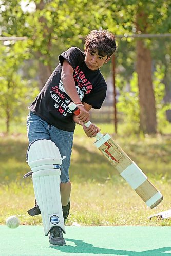 Niv Patel swings at the ball while playing cricket with friends at Crocus Plains Regional Secondary School on Tuesday. (Tim Smith/The Brandon Sun)