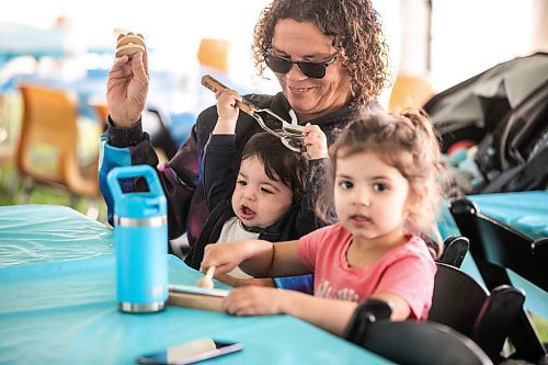 MIKAELA MACKENZIE / WINNIPEG FREE PRESS
	
Kim Venne and her grandkids, Finlay (eight months) and Marielle (three years) MacPherson, take part in the musical spoons workshop at the 6th annual Manitoba Mtis Federation elders and youth gathering at Selkirk Park on Tuesday, Aug. 27, 2024. The gathering brings together elders and youth from across the regions so that the youth can learn traditional skills, hear oral teachings and learn the principles of culturally-focused interactions with knowledge keepers.

Standup.
Winnipeg Free Press 2024