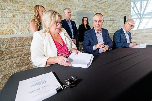 MIKE DEAL / FREE PRESS
(From left) Arlyn Filewich, lead negotiator, MTS, Nathan Martindale, president of the MTS, and Joel Swaan, provincial bargaining chair, MTS, sign the first ever provincial bargaining agreement between teachers and school boards in Manitoba at an event held at the CMHR Tuesday morning.
See Maggie Macintosh story
240827 - Tuesday, August 27, 2024.