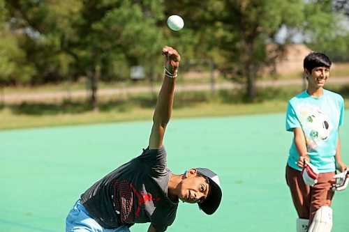 27082024
Devarsh Patel bowls the ball while playing cricket with friends at Crocus Plains Regional Secondary School on Tuesday.
(Tim Smith/The Brandon Sun)