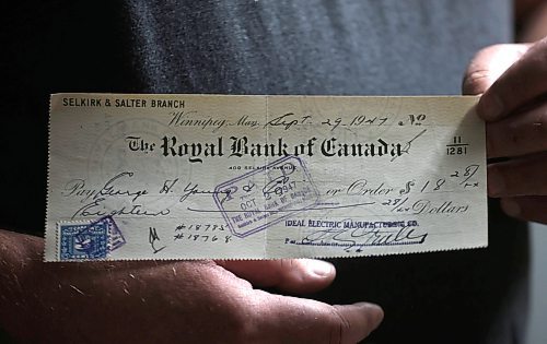 Ruth Bonneville / Free Press
Ideal Electric owner Michael Gruber shows off a cheque from 1947.