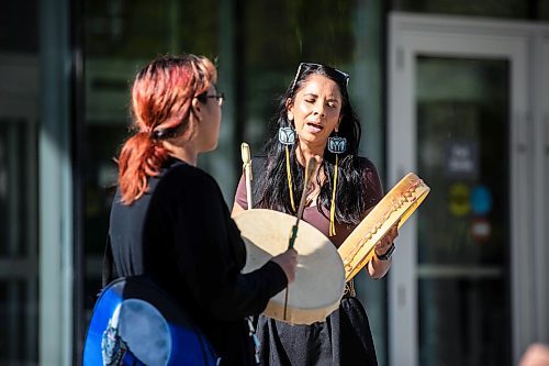 MIKAELA MACKENZIE / WINNIPEG FREE PRESS Amber Flett (right) and Mandy Fenner sing a healing song in front of the law courts on Wednesday, Aug. 28, 2024. The Skibiki sentencing is taking place today. Winnipeg Free Press 2024 