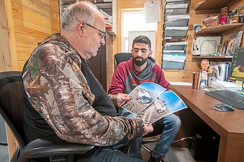 BROOK JONES ./ FREE PRESS
Danny Kleinsasser, 62, (left) looks at photos of the pickup truck he was driving which was T-boned by a gravel truck in March 2024. His son Isaiah Kleinsasser, 25, comforts Danny of Danny's Whole Hog Barbecue &amp; Smokehouse at the family's operation in the RM of Rockwood, Man., Thursday, Aug. 29, 2024.