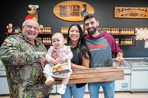 BROOK JONES ./ FREE PRESS
Danny Kleinsasser, 62, (left) of Danny's Whole Hog Barbecue &amp; Smokehouse is pictured with his son Isaiah Kleinsasser, 25, his daughter-in-law Kaeziah Kleinsasser, 24, and his granddaughter seven-month-old Ariyah Kleinsasser. Kleinsasser and his family are pictured at the family's retail store at 12045 PTH 67 in the RM of Rockwood, Man., Thursday, Aug. 29, 2024.