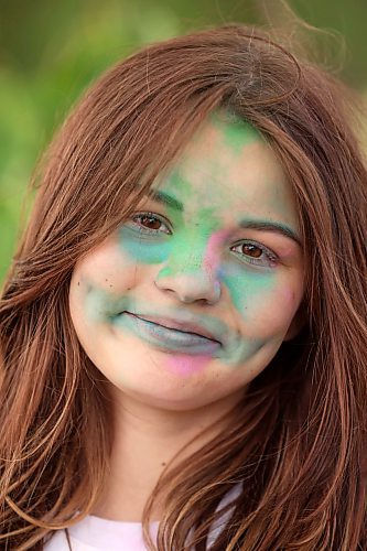 Willow Lundrigan smiles while covered in coloured powder after taking part in the CFB Shilo Fun Run. (Tim Smith/The Brandon Sun)