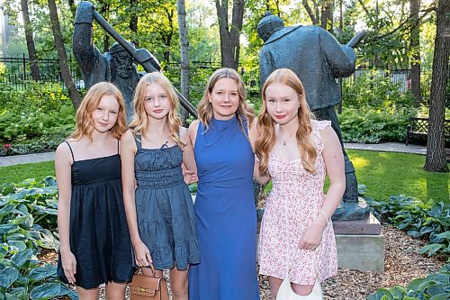 BROOK JONES / FREE PRESS
Theresa Epp (second from far right) of Independent Jewellers is pictured in front of the Lumberjacks statue with her daughters Molly (left), Emma (second from far left) and Abby (right) as they attend A Picnic in Provence - Garden Party 2024 at the Leo Mol Sculpture Garden at Assiniboine Park in Winnipeg, Man., Wednesday, Aug. 28, 2024. The annual fundraiser supports the Assiniboine Park Conservancy and this year's event included 500 guests.