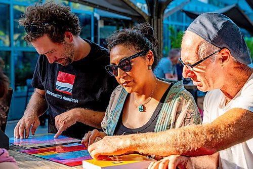 NIC ADAM / FREE PRESS
Organizer Anders Swanson helps Carol Scott and Christian Slomka (from left) learn some Cree and Ojibwe at the free &quot;language tables&quot; offered Wednesday through Friday evenings at the Forks.
240828 - Wednesday, August 28, 2024.

Reporter: Jen Zoratti