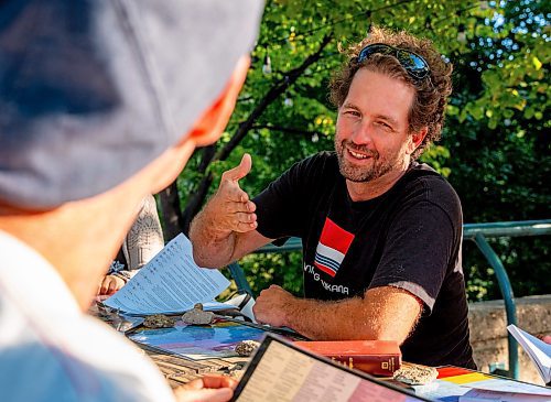 NIC ADAM / FREE PRESS
Anders Swanson (right) helps Christian Slomka learn some Cree and Ojibwe at the free &quot;language tables&quot; offered Wednesday through Friday evenings at the Forks.
240828 - Wednesday, August 28, 2024.

Reporter: Jen Zoratti