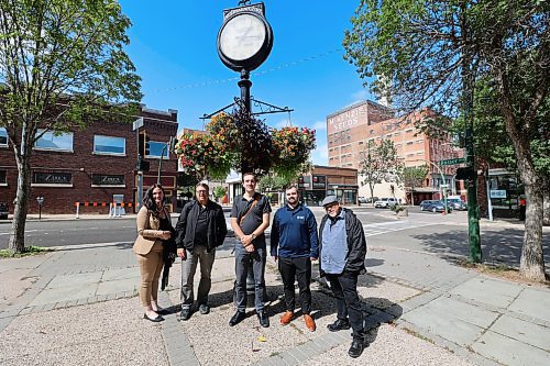 Emmy Sanderson of Brandon Downtown BIZ lead Greg Burnett, Matt Sanscartier and Matt Halchakar of Winnipeg's Downtown Community Safety Partnership and Kevin Walker of Bear Clan Patrol on a walking tour of downtown Brandon on Thursday. (Colin Slark/The Brandon Sun)