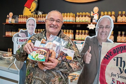 BROOK JONES ./ FREE PRESS
Danny Kleinsasser, 62, of Danny's Whole Hog Barbecue &amp; Smokehouse holds a variety of packaged meats as he stands in the family's retail store at 12045 PTH 67 in the RM of Rockwood, Man., Thursday, Aug. 29, 2024.