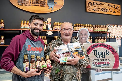 BROOK JONES ./ FREE PRESS
Danny Kleinsasser, 62, (right) of Danny's Whole Hog Barbecue &amp; Smokehouse holds a variety of packaged meats as his son Isaiah Kleinsasser, 25, holds flavours of Danny's Own Barbecue Sauce as they stand in the family's retail store at 12045 PTH 67 in the RM of Rockwood, Man., Thursday, Aug. 29, 2024.