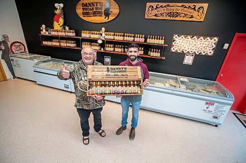 BROOK JONES ./ FREE PRESS
Danny Kleinsasser, 62, (left) of Danny's Whole Hog Barbecue &amp; Smokehouse gives a thumbs up as he is pictured holding various flavours of Danny's Own Barbecue Sauce with his son Isaiah Kleinsasser, 25, while standing in their retail store at 12045 PTH 67 in the RM of Rockwood, Man., Thursday, Aug. 29, 2024.