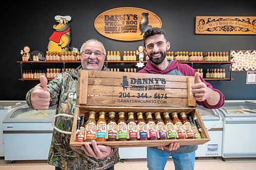 BROOK JONES ./ FREE PRESS
Danny Kleinsasser, 62, (left) of Danny's Whole Hog Barbecue &amp; Smokehouse and his son Isaiah Kleinsasser, 25, give thumbs up as they hold various flavours of Danny's Own Barbecue Sauce while standing in their retail store at 12045 PTH 67 in the RM of Rockwood, Man., Thursday, Aug. 29, 2024.