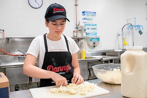 BROOK JONES ./ FREE PRESS
Cassidy Kleinsasser, 14, who is the youngest daughter of Danny Kleinsasser of Danny's Whole Hog Barbecue &amp; Smokehouse is pictured cutting cauliflower for a broccoli and cauliflower salade at the family's operation at 12045 PTH 67 in the RM of Rockwood, Man., Thursday, Aug. 29, 2024.