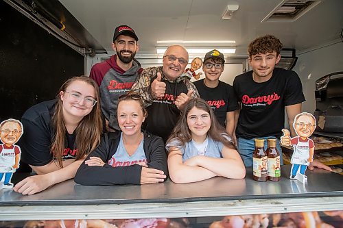 BROOK JONES ./ FREE PRESS
Danny Kleinsasser, 62, (back row second from far left) of Danny's Whole Hog Barbecue &amp; Smokehouse is pictured with family and staff inside a food truck at the family's operation at 12045 PTH 67 in the RM of Rockwood, Man., Thursday, Aug. 29, 2024. Back Row: L-R: Isaiah Kleinsasser, 25, Danny Kleinsasser, 62, Nehemiah Kleinsasser, 16 and Ezra Kleinsasser, 18. Front Row: L-R: Dayna Van Steelant, 20, Kourtenay Schlamp, 34 and Cassidy Kleinsasser, 14.