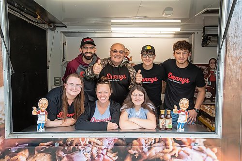 BROOK JONES ./ FREE PRESS
Danny Kleinsasser, 62, (back row second from far left) of Danny's Whole Hog Barbecue &amp; Smokehouse is pictured with family and staff inside a food truck at the family's operation at 12045 PTH 67 in the RM of Rockwood, Man., Thursday, Aug. 29, 2024. Back Row: L-R: Isaiah Kleinsasser, 25, Danny Kleinsasser, 62, Nehemiah Kleinsasser, 16 and Ezra Kleinsasser, 18. Front Row: L-R: Dayna Van Steelant, 20, Kourtenay Schlamp, 34 and Cassidy Kleinsasser, 14.