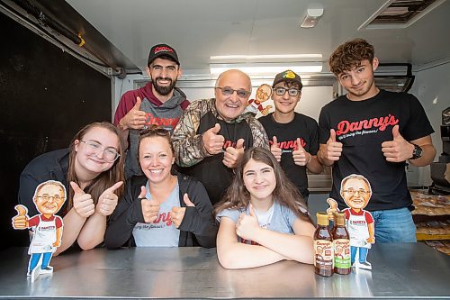 BROOK JONES ./ FREE PRESS
Danny Kleinsasser, 62, (back row second from far left) of Danny's Whole Hog Barbecue &amp; Smokehouse is pictured with family and staff inside a food truck at the family's operation at 12045 PTH 67 in the RM of Rockwood, Man., Thursday, Aug. 29, 2024. Back Row: L-R: Isaiah Kleinsasser, 25, Danny Kleinsasser, 62, Nehemiah Kleinsasser, 16 and Ezra Kleinsasser, 18. Front Row: L-R: Dayna Van Steelant, 20, Kourtenay Schlamp, 34 and Cassidy Kleinsasser, 14.