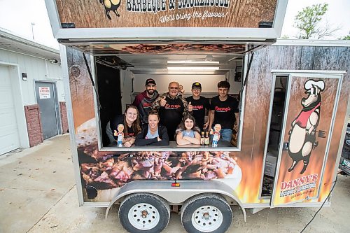 BROOK JONES ./ FREE PRESS
Danny Kleinsasser, 62, (back row second from far left) of Danny's Whole Hog Barbecue &amp; Smokehouse is pictured with family and staff inside a food truck at the family's operation at 12045 PTH 67 in the RM of Rockwood, Man., Thursday, Aug. 29, 2024. Back Row: L-R: Isaiah Kleinsasser, 25, Danny Kleinsasser, 62, Nehemiah Kleinsasser, 16 and Ezra Kleinsasser, 18. Front Row: L-R: Dayna Van Steelant, 20, Kourtenay Schlamp, 34 and Cassidy Kleinsasser, 14.