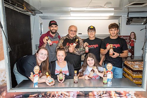 BROOK JONES ./ FREE PRESS
Danny Kleinsasser, 62, (back row second from far left) of Danny's Whole Hog Barbecue &amp; Smokehouse is pictured with family and staff inside a food truck at the family's operation at 12045 PTH 67 in the RM of Rockwood, Man., Thursday, Aug. 29, 2024. Back Row: L-R: Isaiah Kleinsasser, 25, Danny Kleinsasser, 62, Nehemiah Kleinsasser, 16 and Ezra Kleinsasser, 18. Front Row: L-R: Dayna Van Steelant, 20, Kourtenay Schlamp, 34 and Cassidy Kleinsasser, 14.