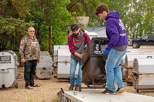 BROOK JONES ./ FREE PRESS
Isaiah Kleinsasser, 25, (middle) and his brother Ezra Kleinsasser, 18, load a cooker onto a trailer as Danny Kleinsasser, 62, of Danny Kleinsasser of Danny's Whole Hog Barbecue &amp; Smokehouse looks on while being pictured at the family's operation at 12045 PTH 67 in the RM of Rockwood, Man., Thursday, Aug. 29, 2024.