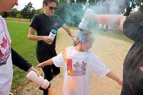 29082024
Nine-year-old Sloane Dumas is covered in coloured powder during the CFB Shilo Fun Run 2024 hosted by CFB Shilo Community Recreation and Shilo MFRC. Donations were taken for cancer research as part of the run and a free barbecue was served after. 
(Tim Smith/The Brandon Sun)