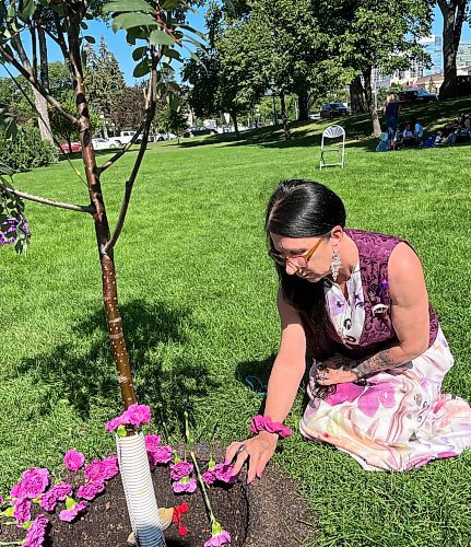 MALAK ABAS / FREE PRESS

- harm reduction advocate Arlene Last-Kolb

Carnations were dropped at the unveiling of a showy mountain ash tree planted on the northwest site of the legislative grounds in remembrance of people who have died or had their lives impacted by a drug overdose or poisoning.

Friday, August 31, 2024