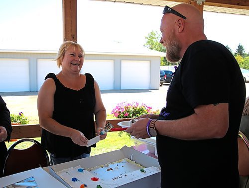 Terri Silvius, executive director at COR Enterprises Inc. in Brandon, shares a laugh with Coun. Tyson Tame (Ward 10) during the grand opening of a new open-air gazebo that was recently built beside COR's main building. (Michele McDougall/The Brandon Sun)   