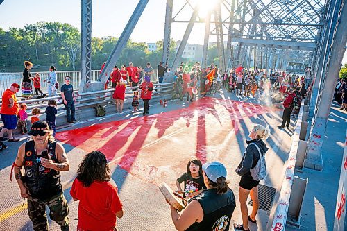 NIC ADAM / FREE PRESS
Family and supporters block off the Harry Lazarenko Bridge  and paint a red dress that reads &#x201c;Justice for Doris&#x201d; Friday evening after Doris Porter was struck and killed on the bridge on August 10th. 
240830 - Friday, August 30, 2024.

Reporter: Jura