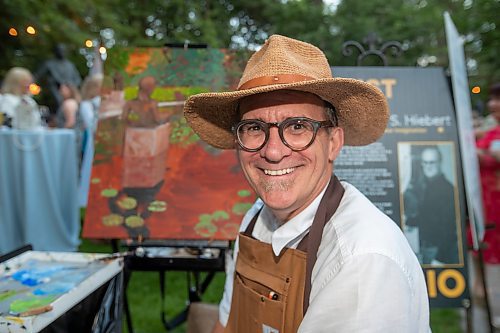 BROOK JONES / FREE PRESS
Artist Andrew S. Hiebert of Ignite Your Imagination is all smiles as paints an acrylic painting during A Picnic in Provence - Garden Party 2024 at the Leo Mol Sculpture Garden at Assiniboine Park in Winnipeg, Man., Wednesday, Aug. 28, 2024. The annual fundraiser supports the Assiniboine Park Conservancy and this year's event included 500 guests.