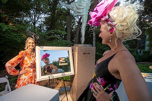 BROOK JONES / FREE PRESS
Chocolate Zen Bakery co-owners Barbara Rudiak (right) who is looking at her reflection in a mirror as Bonnie Greschuk looks on during A Picnic in Provence - Garden Party 2024 at the Leo Mol Sculpture Garden at Assiniboine Park in Winnipeg, Man., Wednesday, Aug. 28, 2024. The annual fundraiser supports the Assiniboine Park Conservancy and this year's event included 500 guests.