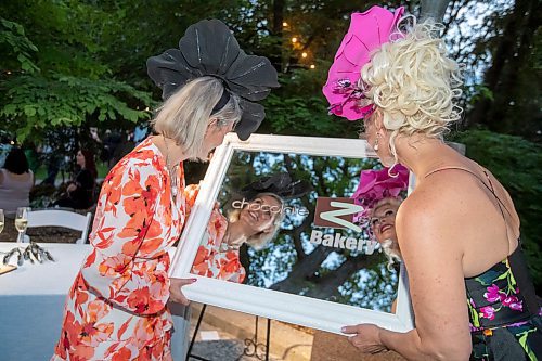 BROOK JONES / FREE PRESS
Chocolate Zen Bakery co-owners Bonnie Greschuk (left) and Barbara Rudiak look at their reflections in a mirror during A Picnic in Provence - Garden Party 2024 at the Leo Mol Sculpture Garden at Assiniboine Park in Winnipeg, Man., Wednesday, Aug. 28, 2024. The annual fundraiser supports the Assiniboine Park Conservancy and this year's event included 500 guests.