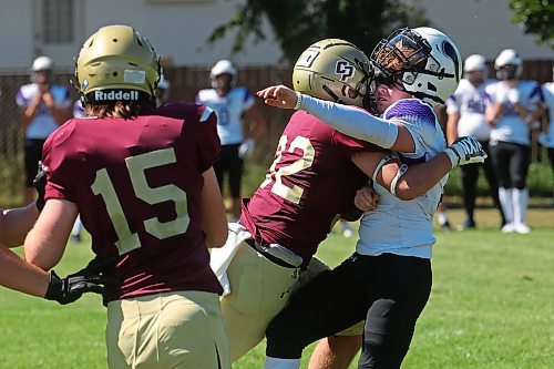 30082024
The helmet of quarterback #10 of the Vincent Massey Vikings is knocked back as he is tackled by #32 of the Crocus Plainsmen during a high school football scrimmage at Vincent Massey High School on Friday in advance of the regular season. 
(Tim Smith/The Brandon Sun)