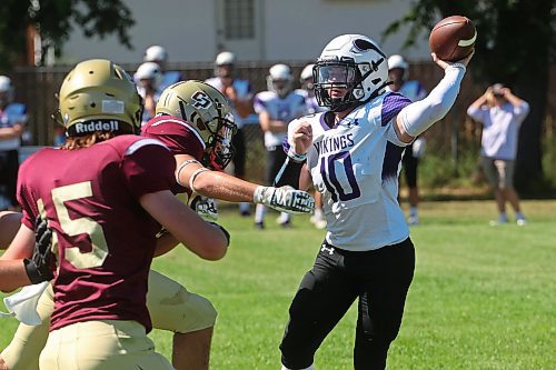 30082024
quarterback #10 of the Vincent Massey Vikings throws the ball before being tackled by #32 of the Crocus Plainsmen during a high school football scrimmage  at Vincent Massey High School on Friday in advance of the regular season. 
(Tim Smith/The Brandon Sun)