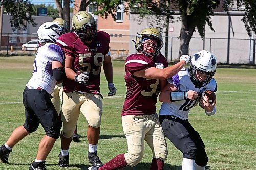 30082024
#35 of the Crocus Plainsmen tackles quarterback #10 of the Vincent Massey Vikings during a high school football scrimmage at Vincent Massey High School on Friday in advance of the regular season. 
(Tim Smith/The Brandon Sun)