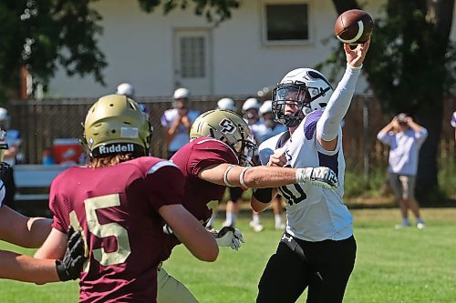 30082024
Quarterback #10 of the Vincent Massey Vikings throws the ball as he is tackled by #32 of the Crocus Plainsmen during a high school football scrimmage at Vincent Massey High School on Friday in advance of the regular season. 
(Tim Smith/The Brandon Sun)