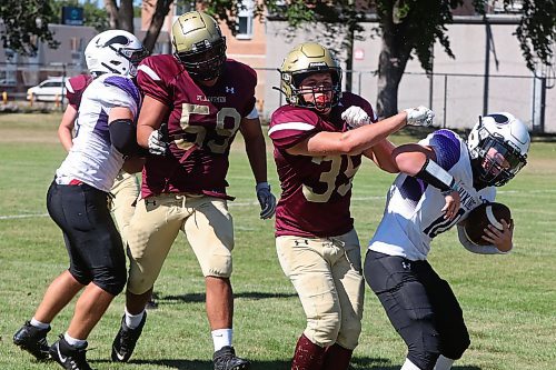 30082024
#35 of the Crocus Plainsmen tackles quarterback #10 of the Vincent Massey Vikings during a high school football scrimmage at Vincent Massey High School on Friday in advance of the regular season. 
(Tim Smith/The Brandon Sun)