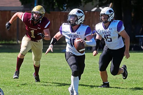 30082024
#10 of the Vincent Massey Vikings runs the ball and looks for an opening for a pass during a high school football scrimmage against the Crocus Plainsmen at Vincent Massey High School on Friday in advance of the regular season. 
(Tim Smith/The Brandon Sun)