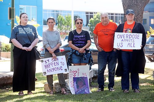 30082024
Participants listen to drummers perform a wildflower song prior to the International Toxic Drug Poisoning Awareness Day walk in downtown Brandon on Friday. The walk began and ended at Princess Park and was followed by speakers and a lunch.  (Tim Smith/The Brandon Sun)