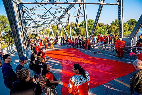 NIC ADAM / FREE PRESS
Family and supporters block off the Harry Lazarenko Bridge  and paint a red dress that reads &#x201c;Justice for Doris&#x201d; Friday evening after Doris Porter was struck and killed on the bridge on August 10th. 
240830 - Friday, August 30, 2024.

Reporter: Jura