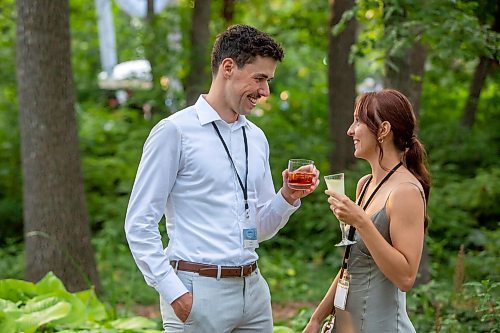 BROOK JONES / FREE PRESS
Tomas Boyle (left), who is a native of Melbourne, Australia and works as a lights tech lead at Lights Unlimited in Winnipeg, and his wife Heather Herms, who is a nursing student at RRC Polytech, are about to cheers their drinks as they attend A Picnic in Provence - Garden Party 2024 at the Leo Mol Sculpture Garden at Assiniboine Park in Winnipeg, Man., Wednesday, Aug. 28, 2024. The annual fundraiser supports the Assiniboine Park Conservancy and this year's event included 500 guests.