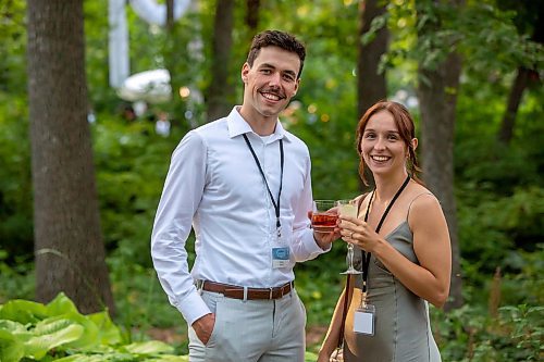 BROOK JONES / FREE PRESS
Tomas Boyle (left), who is a native of Melbourne, Australia and works as a lights tech lead at Lights Unlimited in Winnipeg, and his wife Heather Herms, who is a nursing student at RRC Polytech, cheers their drinks as they attend A Picnic in Provence - Garden Party 2024 at the Leo Mol Sculpture Garden at Assiniboine Park in Winnipeg, Man., Wednesday, Aug. 28, 2024. The annual fundraiser supports the Assiniboine Park Conservancy and this year's event included 500 guests.