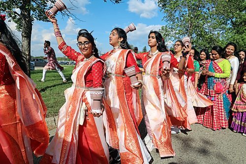 Dancers swirl cups in the air during a parade for the inauguration of the first BAPS Hindu temple in Brandon. (Connor McDowell/Brandon Sun)