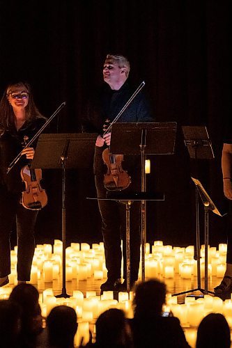 BROOK JONES / FREE PRESS
Elation Pauls (left) on violin and Chris Anstey on fiddle stand during the ovation from the crowd after performing A Tribute To Coldplay as part of the Fever Candlelight Series at the Winnipeg Art Gallery in Winnipeg, Man., Friday, Aug. 30, 2024. Musicians also performing from the Listeso Music Group while surrounded by candles on stage were Elise Lavall&#xe9;e on viloa and Samuel Nadurak performs on cello.