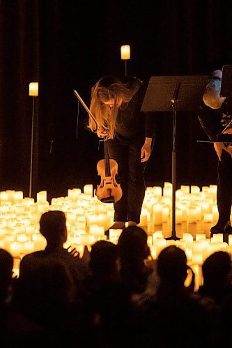 BROOK JONES / FREE PRESS
Elation Pauls (left) on violin and Chris Anstey on fiddle take a bow after performing A Tribute To Coldplay as part of the Fever Candlelight Series at the Winnipeg Art Gallery in Winnipeg, Man., Friday, Aug. 30, 2024. Musicians also performing from the Listeso Music Group while surrounded by candles on stage are Elise Lavall&#xe9;e on viloa and Samuel Nadurak performs on cello.