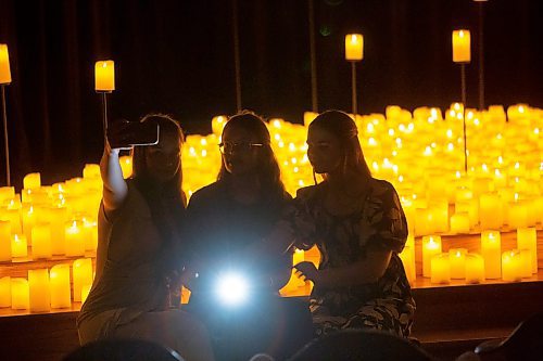 BROOK JONES / FREE PRESS
Edda Kruerger (left), who is from Germany, takes a selfie with her friend Jouline Kakostenko (middle), who is also from Germany, and Angelina Hiebert (right), who is from Steinbach, after watching A Tribute To Coldplay as part of the Fever Candlelight Series at the Winnipeg Art Gallery in Winnipeg, Man., Friday, Aug. 30, 2024. Musicians from the Listeso Music Group which included Elation Pauls on violin, Chris Anstey on fiddle, Elise Lavall&#xe9;e on viloa and Samuel Nadurak on cello were surrounded by candles on stage as they performed 11 songs during a 65 minute program.