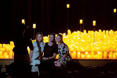 BROOK JONES / FREE PRESS
Edda Kruerger (left) and Jouline Kakostenko (middle) who are visiting Winnipeg from Germany and Angelina Hiebert (right) who is from Steinbach have their photo taken by Subaha Raman after watching A Tribute To Coldplay as part of the Fever Candlelight Series at the Winnipeg Art Gallery in Winnipeg, Man., Friday, Aug. 30, 2024. Musicians from the Listeso Music Group which included Elation Pauls on violin, Chris Anstey on fiddle, Elise Lavall&#xe9;e on viloa and Samuel Nadurak on cello were surrounded by candles on stage as they performed 11 songs during a 65 minute program.