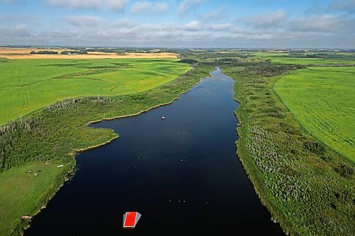 19082024
An aerial view of the thin, small body of water surrounded by prairie where world-class ski jumper Casey Mommer trains in Westman. Mommer, who grew up training at some of the best waterski training areas in the world, namely in Florida, now trains to compete at the top of his sport on the Manitoba prairie. (Tim Smith/The Brandon Sun)default