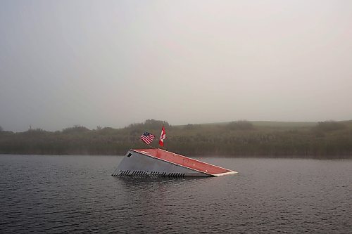 23082024
Fog blankets the lake with Casey Mommer&#x2019;s jump on an early August morning. The flags and reflective compact discs are used to deter birds and ducks from making a mess of the jump when it isn&#x2019;t in use. 
(Tim Smith/The Brandon Sun)