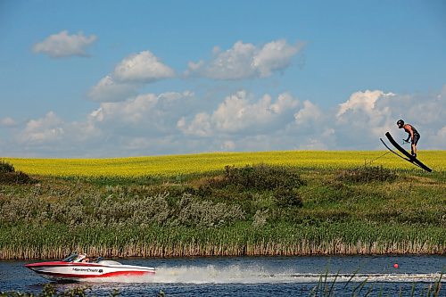 31072024
A crop of canola in bloom blankets the prairie bordering the small lake/pond as ski jumper Casey Mommer trains in late July. Mommer has been jumping as much as possible this summer, when the wind is right. Most sessions consist of two sets of three or four jumps, which is about as much as Mommer&#x2019;s feet can take in the incredibly tight bindings. 
(Tim Smith/The Brandon Sun)